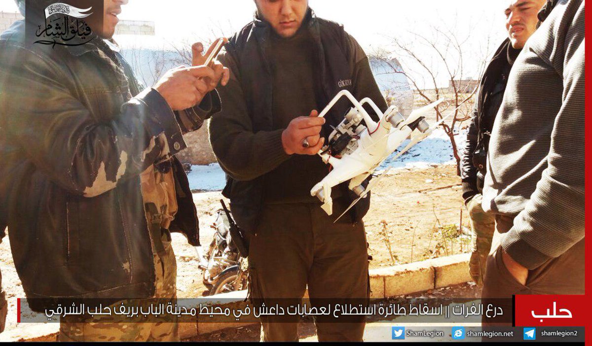 Faylaq Al-Sham fighters in Al-Bab area showing a downed ISIS quadcopter drone (Dji Dhantom model)  and  ACV-15