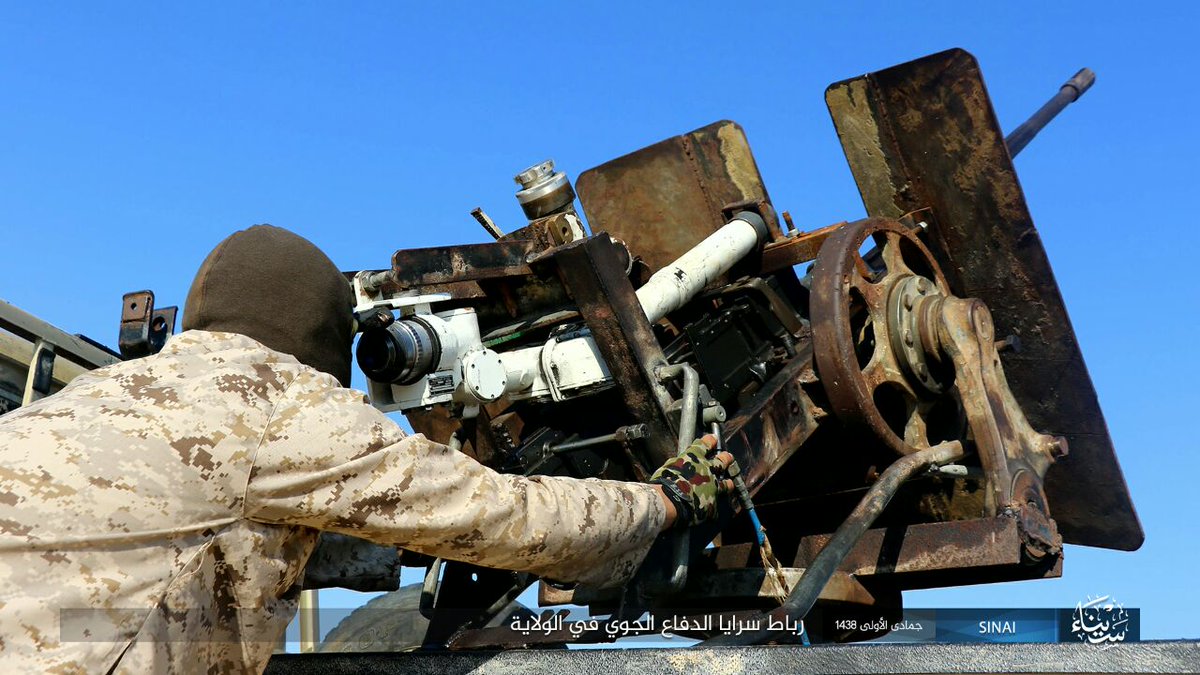 Egypt: ISIS/Sinai Province photo with its Air Defense Unit on guard duty showing off a 9K32/Strela-2 (replica?)  and AA gun equipped technical  