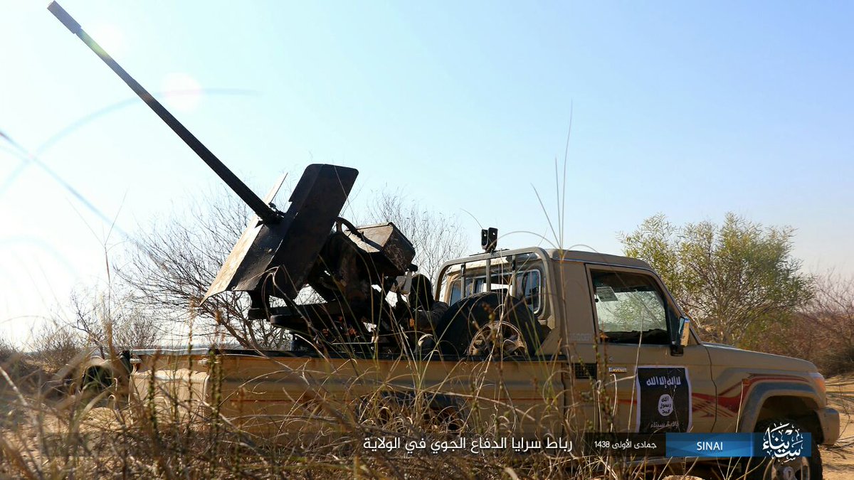 Egypt: ISIS/Sinai Province photo with its Air Defense Unit on guard duty showing off a 9K32/Strela-2 (replica?)  and AA gun equipped technical  