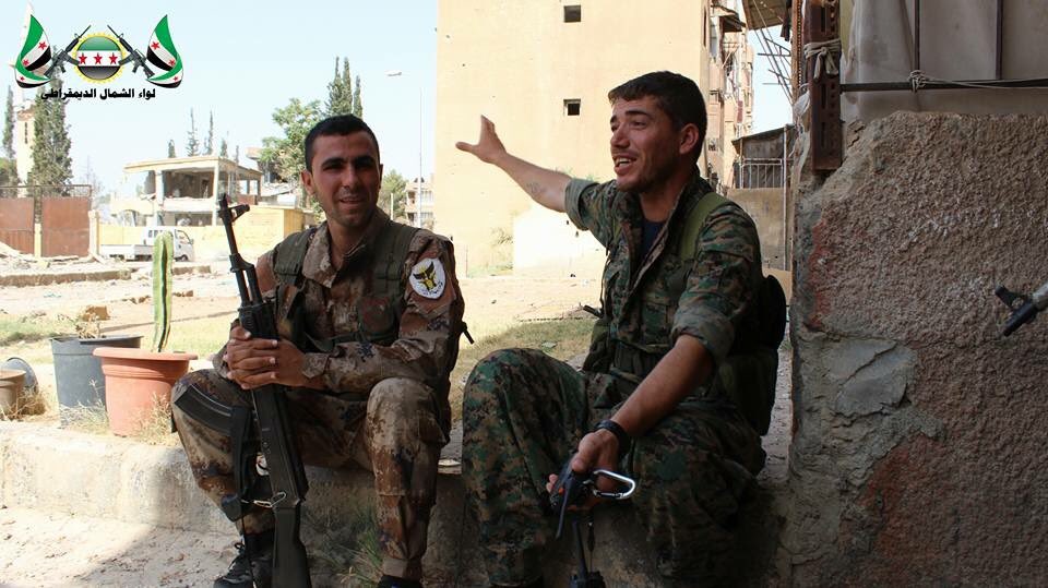 Fighters from the Northern Democratic Brigade and Jabhat al-Akrad resting after clashes with ISIS in Raqqa city  