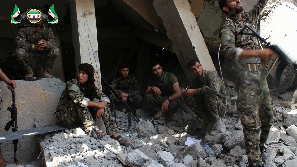Fighters from the Northern Democratic Brigade and Jabhat al-Akrad resting after clashes with ISIS in Raqqa city  